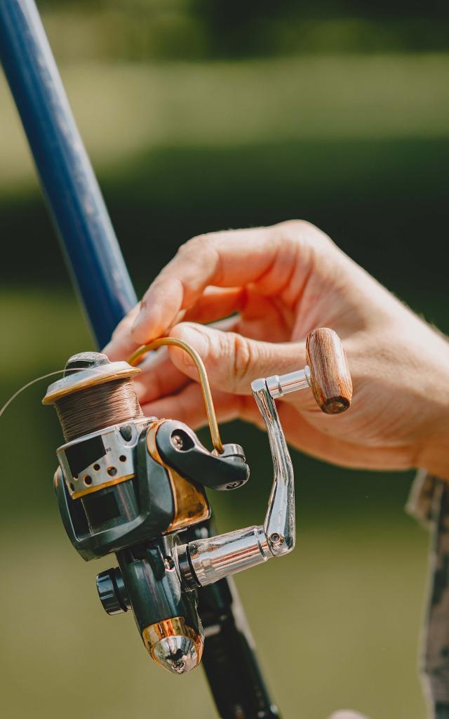 A man fishing on a lake. Guy in a uniform.