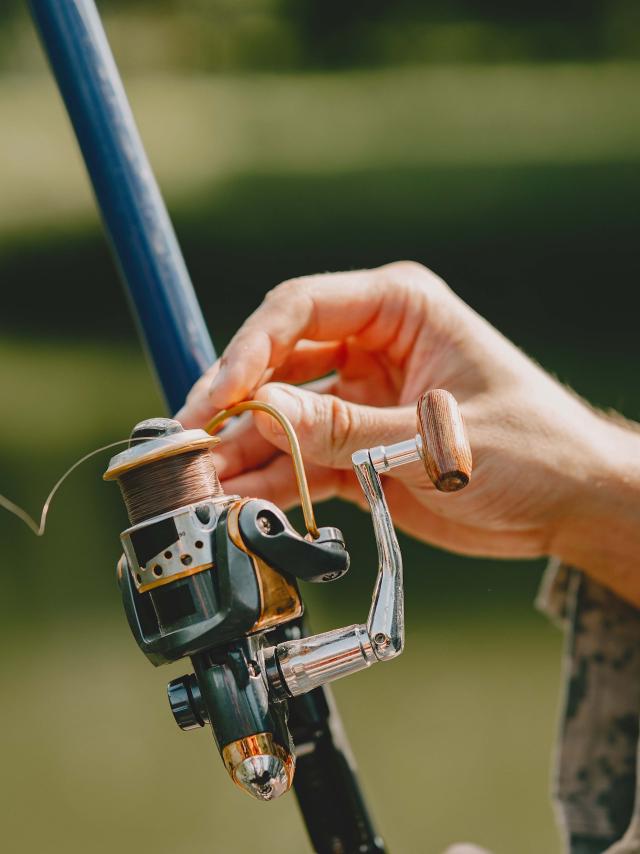 A man fishing on a lake. Guy in a uniform.